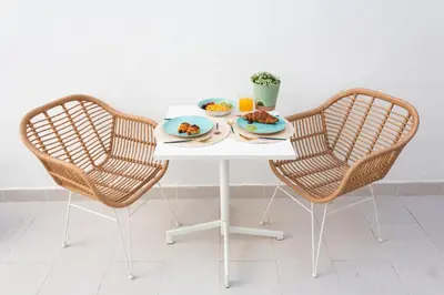 two chairs and a table with two plates of food on it at Divino Hotel Boutique in Sitges