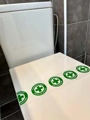 a white toilet with green recycle signs on it at True Design in Heart of Noble BCN in Barcelona