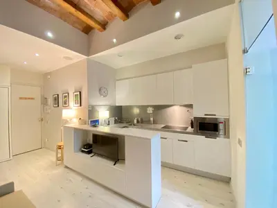 a kitchen with white cabinets and a counter top at True Design in Heart of Noble BCN in Barcelona