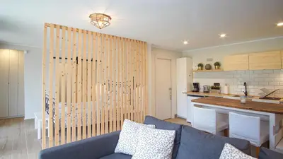 a living room with a couch and a kitchen at Holidays en Arenys de Mar y Montaña in Arenys de Mar