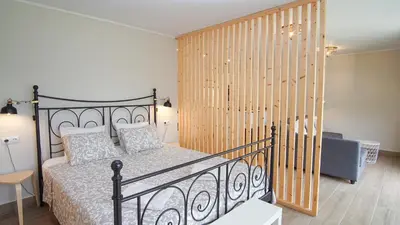 a bedroom with a bed and a wooden wall at Holidays en Arenys de Mar y Montaña in Arenys de Mar