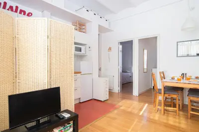 a living room with a television and a dining room at Barcelona cozy apartment in Barcelona