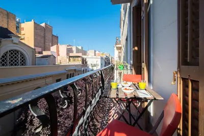 a balcony with a table and chairs on a balcony at Barcelona cozy apartment in Barcelona