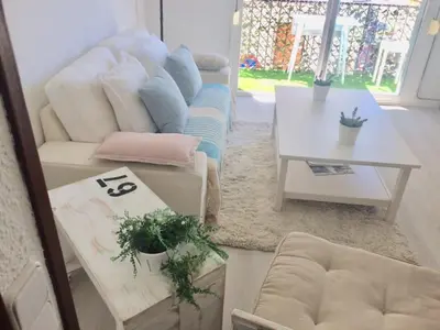a living room with a couch and a table at SITGES Apartment PALLARÉS in Sitges