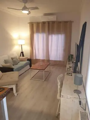 a living room with a couch and a table at SITGES Apartment PALLARÉS in Sitges