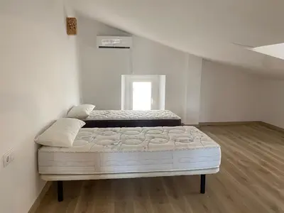 a white bedroom with a bed in a room at Masia Can Llonch in Palau-Solità i Plegamans