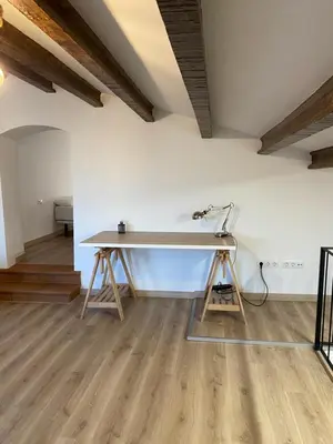 a desk in the middle of a room at Masia Can Llonch in Palau-Solità i Plegamans