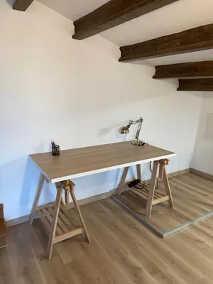 a wooden desk with a lamp on top of it at Masia Can Llonch in Palau-Solità i Plegamans