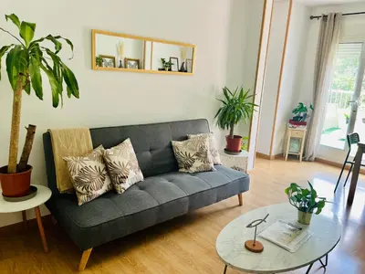 a living room with a couch and a table at Attic360Views in Barcelona