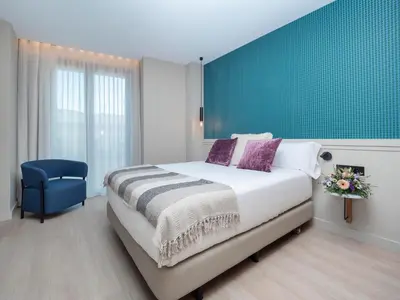 a woman sitting at a table eating a piece of food at ARCELON HOTEL - From 2023 in Barcelona