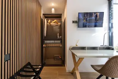 a patio with chairs and a table and a swing at The Collection Barcelona - Amazing 3 Bedroom Apartment with indoor POOL in Barcelona