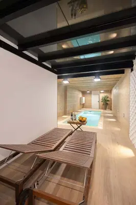 two bottles of wine on a table with a bowl of fruit at The Collection Barcelona - Amazing 3 Bedroom Apartment with indoor POOL in Barcelona