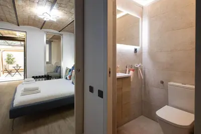 a walk in closet with a black and wooden wall at The Collection Barcelona - Amazing 3 Bedroom Apartment with indoor POOL in Barcelona