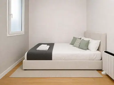 a living room with a white couch and a brick wall at The Collection Barcelona - Arc de Triomf Luxury Modern 2-Bedroom 2-Bathroom in Barcelona