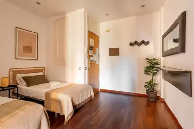 a lobby with a large door and a chandelier at The Collection Barcelona - Plaza Urquinaona Cozy and comfortable in Barcelona