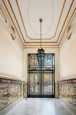 an empty room with a large window and a chandelier at The Collection Barcelona - Plaza Urquinaona Cozy and comfortable in Barcelona