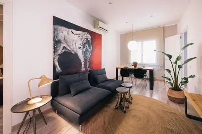a living room with a couch and a table at The Collection Barcelona - Comfortable 3-bedroom next to Sagrada Familia in Barcelona