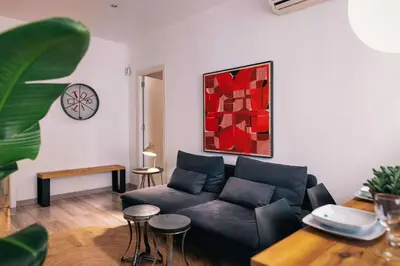 a living room with a couch and a table at The Collection Barcelona - Comfortable 3-bedroom next to Sagrada Familia in Barcelona