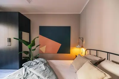 a bedroom with a bed and a painting on the wall at The Collection Barcelona - Comfortable 3-bedroom next to Sagrada Familia in Barcelona
