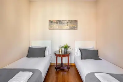 two beds sitting next to each other in a room at The Collection Barcelona - Elegant 3-bedroom Apartment in the Heart of BCN in Barcelona