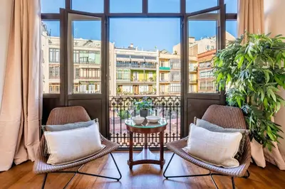 a balcony with two chairs and a table at The Collection Barcelona - Elegant 3-bedroom Apartment in the Heart of BCN in Barcelona