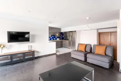 a bedroom with a bed and a couch at The Collection Barcelona - Amazing 3 bedroom penthouse in Plaza España in Barcelona