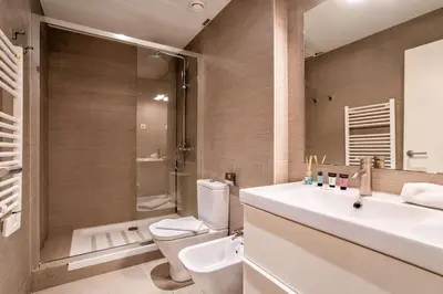 a bathroom with a sink and a toilet and a shower at The Collection Barcelona - Stylish and centric 2-bedroom apartment with Terrace in Eixample in Barcelona