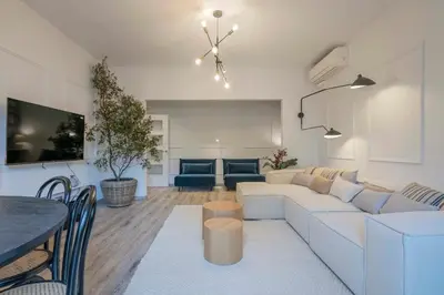 a living room with a white couch and a table at The Collection Barcelona - Luxury 4-bedrooms in Rambla de Catalunya in Barcelona