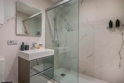 a bathroom with a glass shower and a sink at The Collection Barcelona - Luxury 4-bedrooms in Rambla de Catalunya in Barcelona