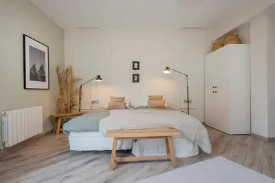 a bedroom with a large bed and a wooden floor at The Collection Barcelona - Luxury 4-bedrooms in Rambla de Catalunya in Barcelona