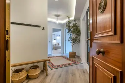 a hallway with a wooden door and a room with a bench at The Collection Barcelona - Luxury 4-bedrooms in Rambla de Catalunya in Barcelona