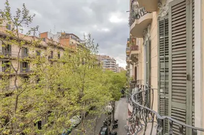 a street in a city with buildings and trees at The Collection Barcelona - Elegant 4 bedrooms 3 bathrooms Catalan home in Barcelona