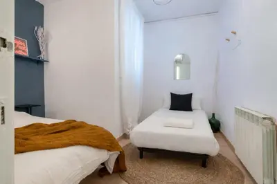 a bedroom with a bed with a brown blanket on it at The Collection Barcelona - Elegant 4 bedrooms 3 bathrooms Catalan home in Barcelona