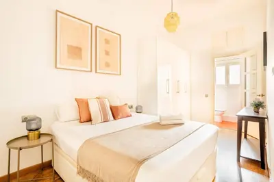 a white bedroom with a large bed in a room at The Collection Barcelona - Pl Universitat Bright and cozy 2BD - 2BTH in Barcelona