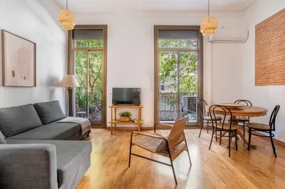 a living room with a couch and a table at The Collection Barcelona - Pl Universitat Bright and cozy 2BD - 2BTH in Barcelona