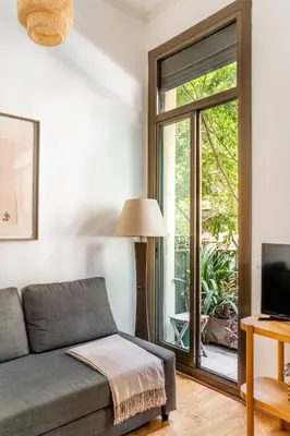 a kitchen with white cabinets and a red counter top at The Collection Barcelona - Pl Universitat Bright and cozy 2BD - 2BTH in Barcelona