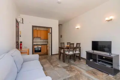 a living room with a table and chairs and a couch at The Collection Barcelona -3BD with private terrace right by Sagrada Familia in Barcelona
