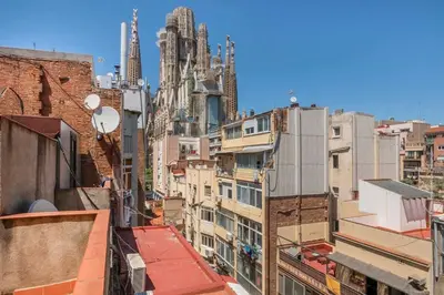 a bedroom with a bed with pink pillows on it at The Collection Barcelona -3BD with private terrace right by Sagrada Familia in Barcelona
