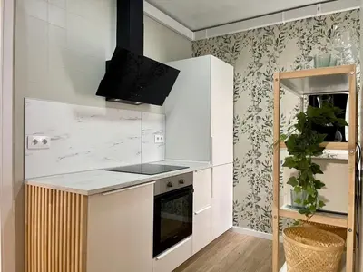 a kitchen with a white counter top and a stove at The Collection Barcelona - Poble Sec - Modern & comfy 3 bedrooms in Barcelona