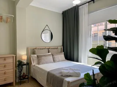 a bedroom with a bed with a mirror and a window at The Collection Barcelona - Poble Sec - Modern & comfy 3 bedrooms in Barcelona