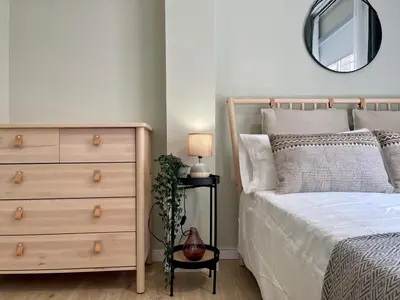 a bedroom with a bed and a dresser and a mirror at The Collection Barcelona - Poble Sec - Modern & comfy 3 bedrooms in Barcelona