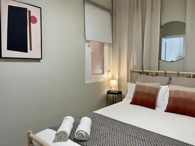 a bedroom with a bed with two towels on it at The Collection Barcelona - Poble Sec - Modern & comfy 3 bedrooms in Barcelona