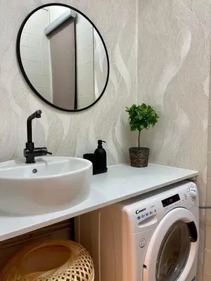 a bathroom with a sink and a washing machine at The Collection Barcelona - Poble Sec - Modern & comfy 3 bedrooms in Barcelona