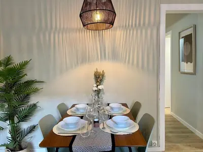 a dining room table with chairs and a chandelier at The Collection Barcelona - Poble Sec - Modern & comfy 3 bedrooms in Barcelona