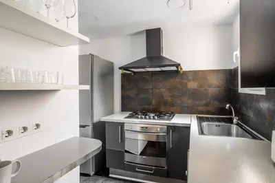 a kitchen with a stove and a sink at The Collection Barcelona - Exclusive Luxe Design - Large Tranquil Penthouse in Barcelona