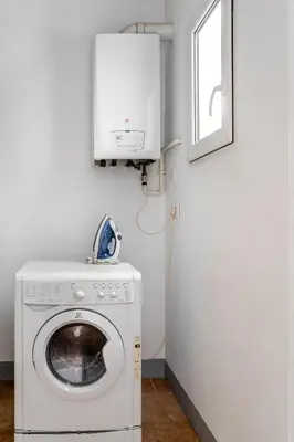 a laundry room with a washing machine and a window at The Collection Barcelona - Exclusive Luxe Design - Large Tranquil Penthouse in Barcelona