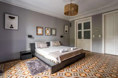 a bedroom with a large bed and a rug at The Collection Barcelona - Ronda Sant Pere in Barcelona