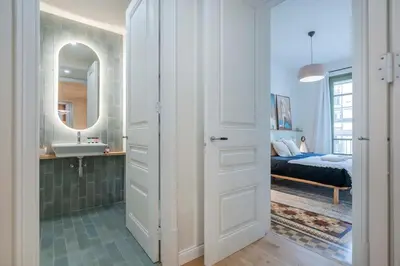 a bathroom with a sink and a mirror at The Collection Barcelona - Exclusive Paseo de Gracia 5BD 5BTH with terrace in Barcelona
