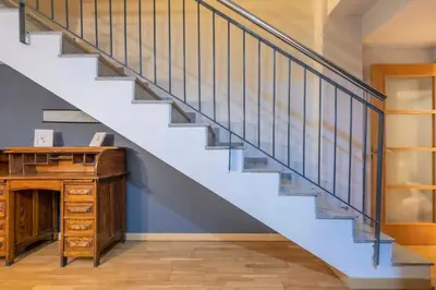 a hallway with stairs with a blue wall at The Collection Barcelona - Bright and modern Duplex with terrace in Eixample district P1 in Barcelona