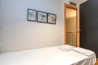 a room with a bed and a hallway with a door at The Collection Barcelona - Bright and modern Duplex with terrace in Eixample district P1 in Barcelona